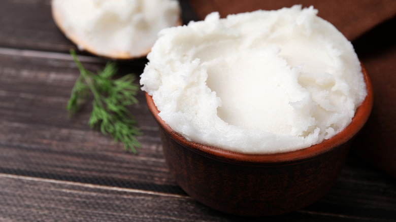 Pork lard in bowl on wooden table