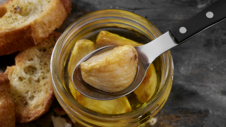 Garlic confit in a jar of oil