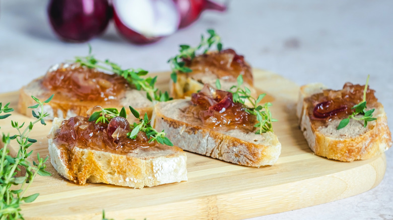 Onion confit on pieces of toasted bread with fresh thyme