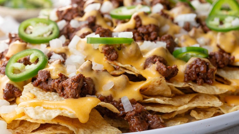 closeup cheesy sloppy joe nachos on plate