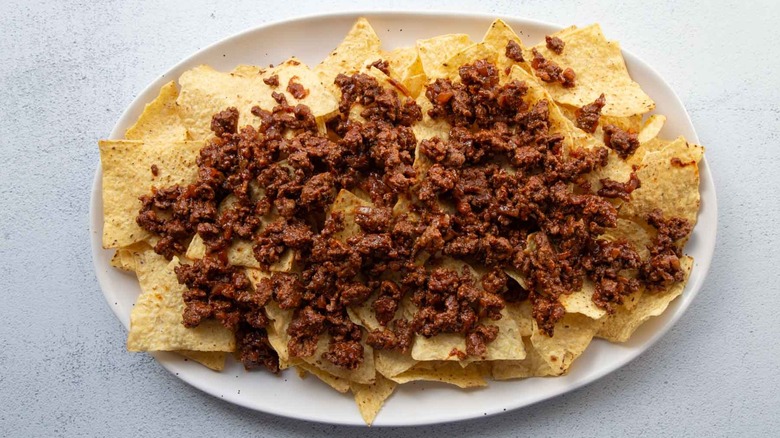 tortilla chips with ground beef on platter