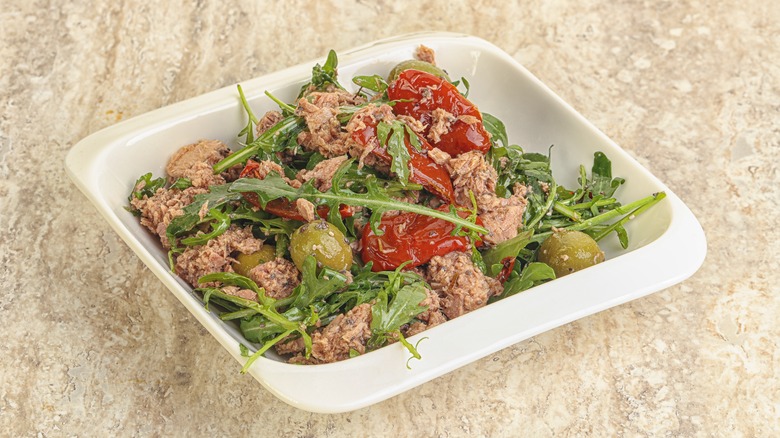 tuna salad with dried tomatoes, olives, and greens