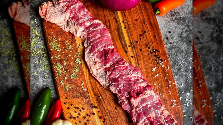 Raw skirt steak cut on a cutting board