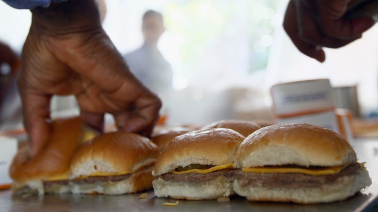 hand working on white castle sliders