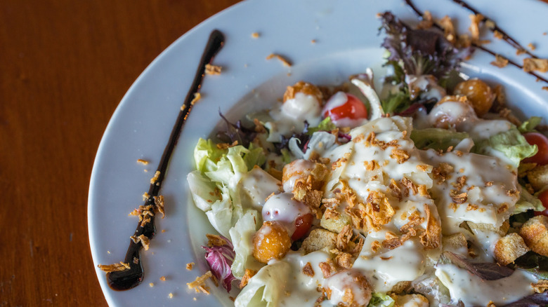 Caesar salad slathered with dressing