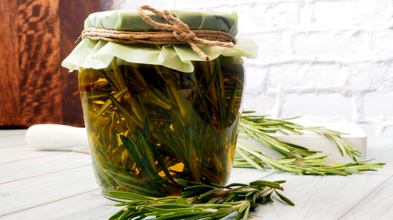 A sealed jar of rosemary infused olive oil