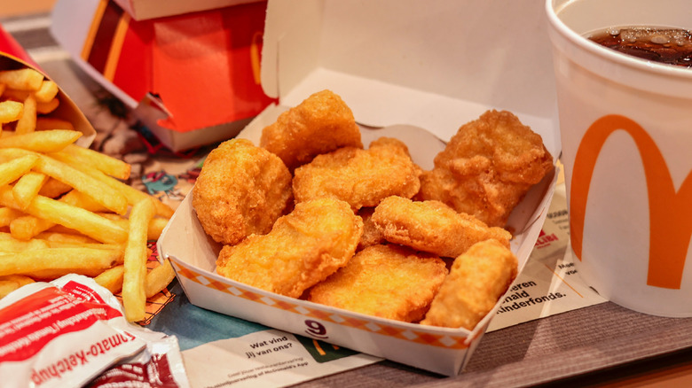 Box of chicken mcnuggets from McDonald's with fries and soda