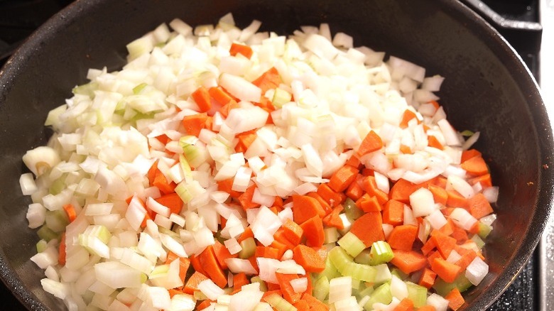 A mirepoix base cooking in a skillet