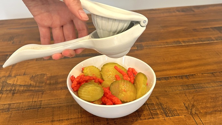 Making Hot Cheetos and pickles snack