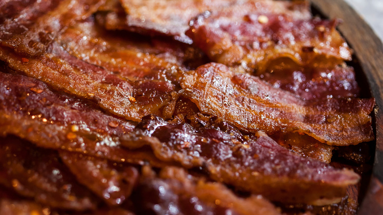 Close-up of a bowl of candied bacon with red pepper flakes