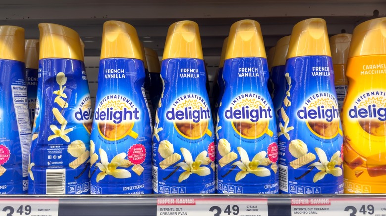 Bottles of International Delight coffee creamer on a store shelf