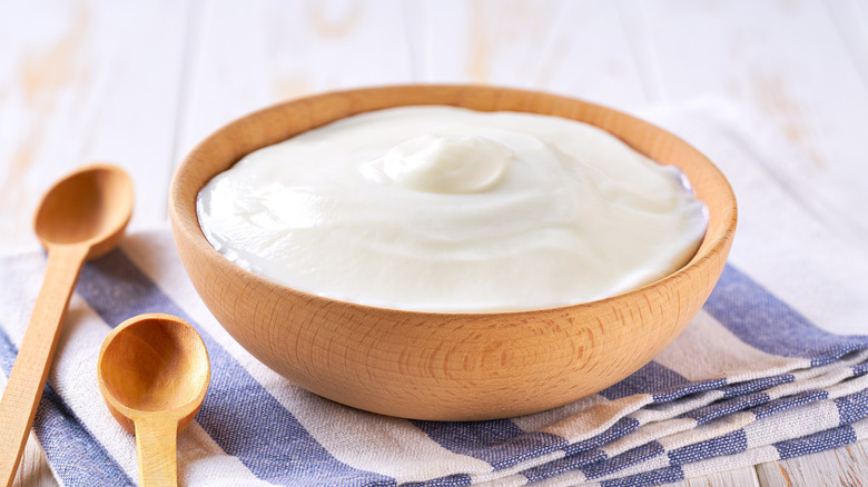 wooden bowl of greek yogurt with spoons