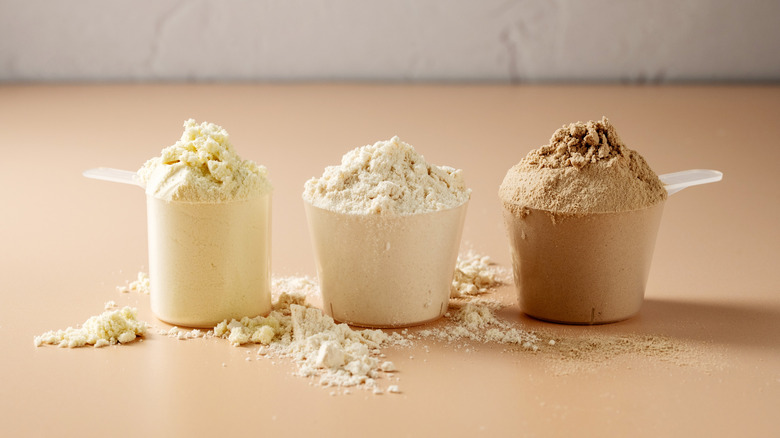 Three scoops of different-flavored protein powder