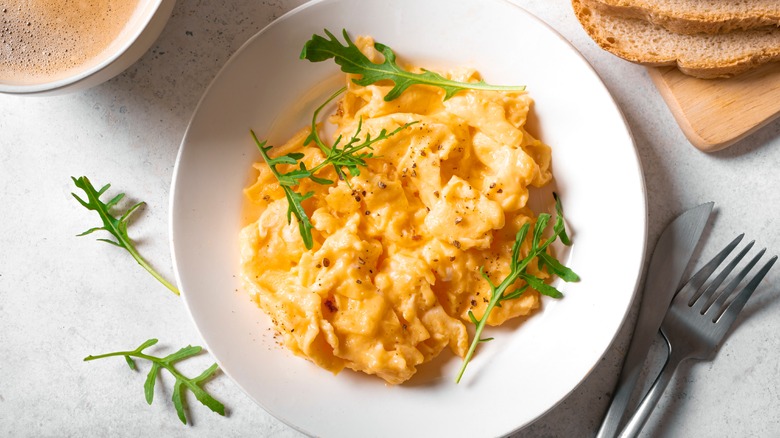 Scrambled eggs on plate with fork