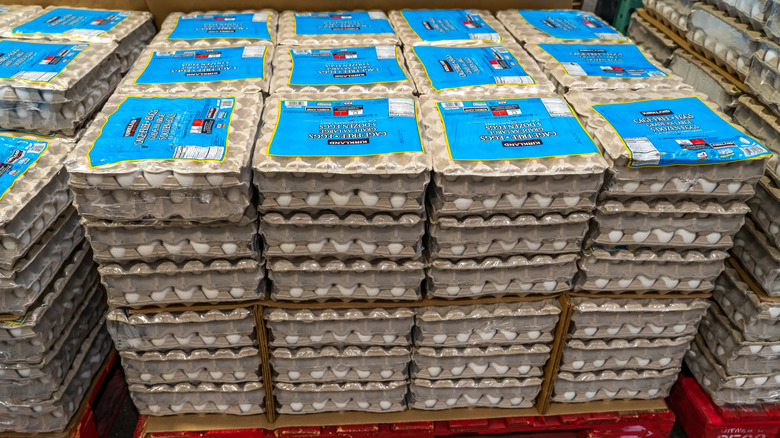 Cartons of Costco Kirkland brand eggs are shown stacked on a pallet