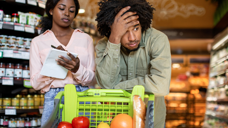 Man looking unenthusiastic about groceries
