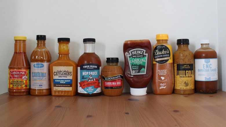 An array of Carolina BBQ sauces lined up on a wooden table