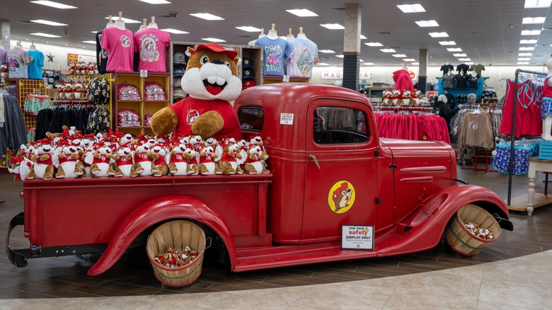 Old red truck with Buc-ee's toys inside store