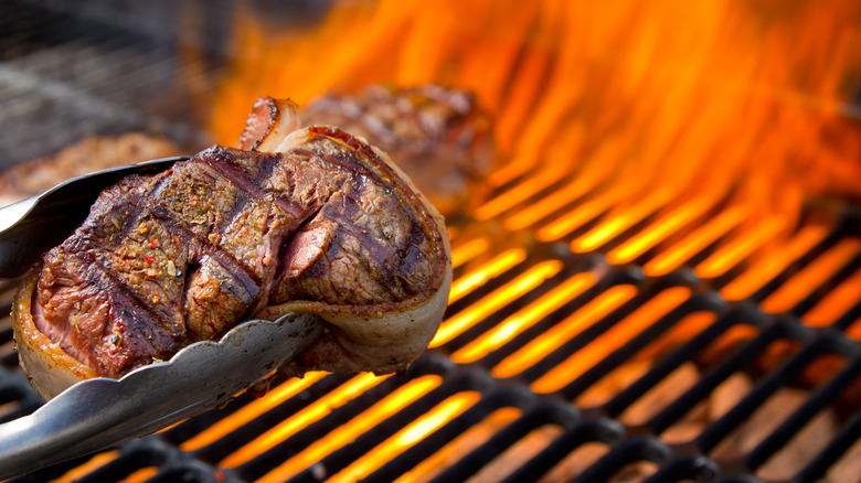 Bacon-wrapped filet mignon on the grill