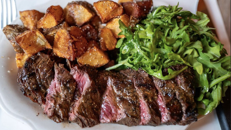 Grilled hanger steak with arugula and roasted potatoes