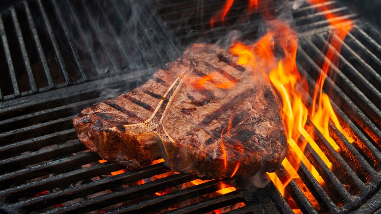 A porterhouse steak on a hot grill