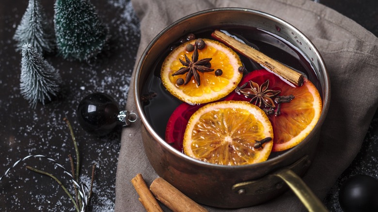 Mulled wine with spices and orange slices in a pot