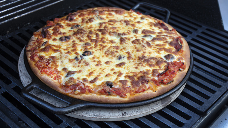 Large pizza on a grill