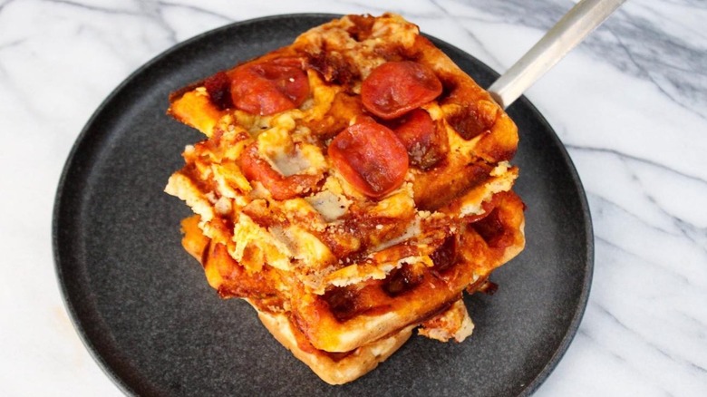 Waffled pizza on black plate