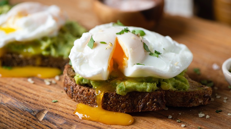 poached egg atop toast and avocado