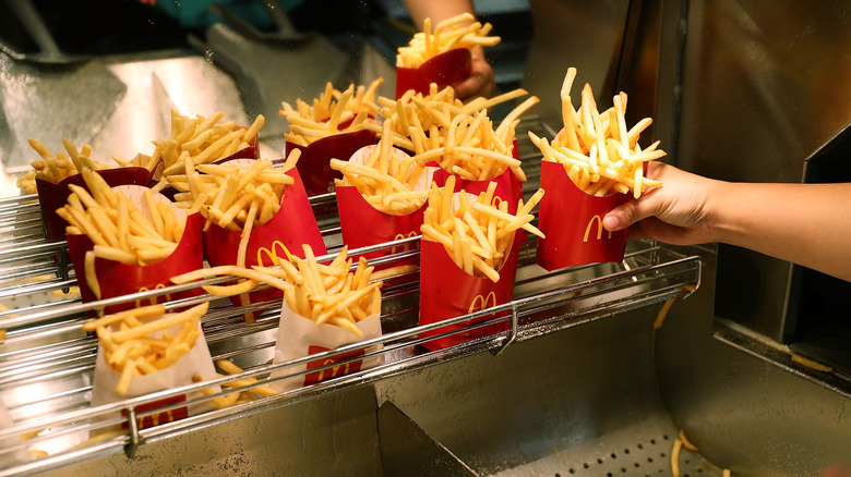 McDonald's packaged fries on a cooling rack in restaurant