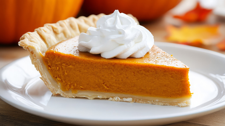 slice of pumpkin pie with whipped cream