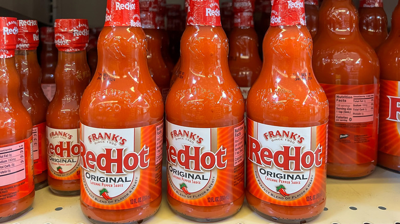 Bottles of Frank's Red Hot sauce on shelf