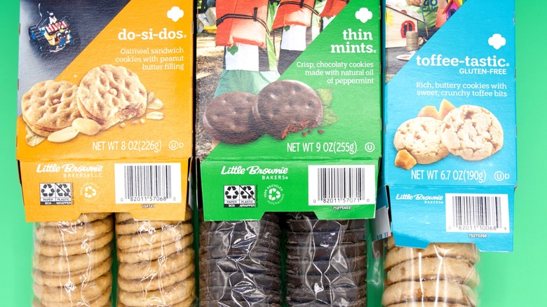 Boxes of Girl Scout cookies on green background