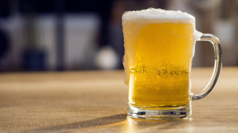 A frosty mug of beer on a wooden surface