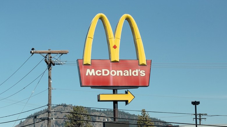 McDonald's golden arches sign against blue sky