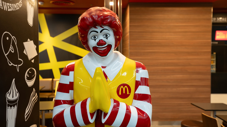 Ronald McDonald statue performing wai to greet Thai customers