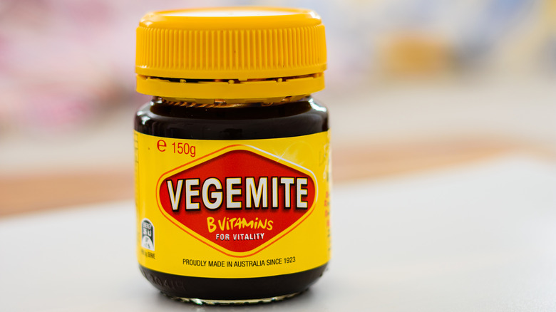 A jar of Australian Vegemite paste with yellow and red packaging