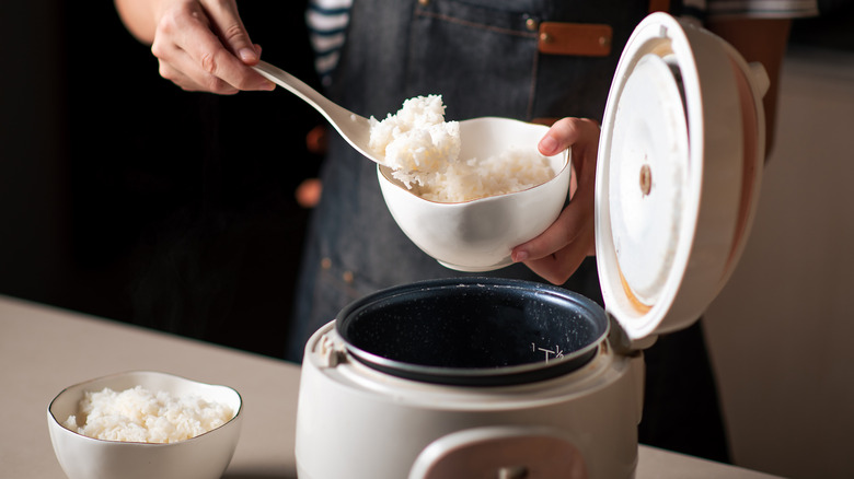 Home cook using a rice cooker