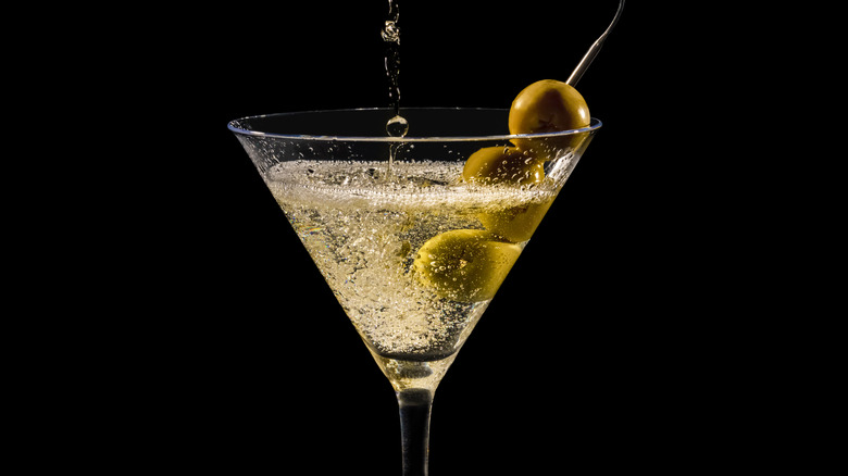 Fizzing martini with three skewered olives