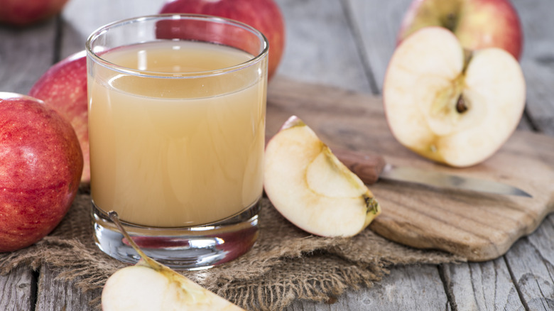 apple cider in cup by apples