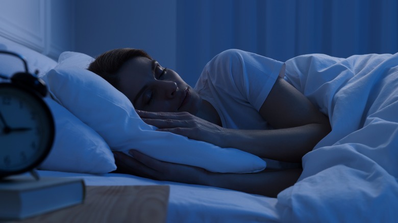 Woman sleeping in dark room