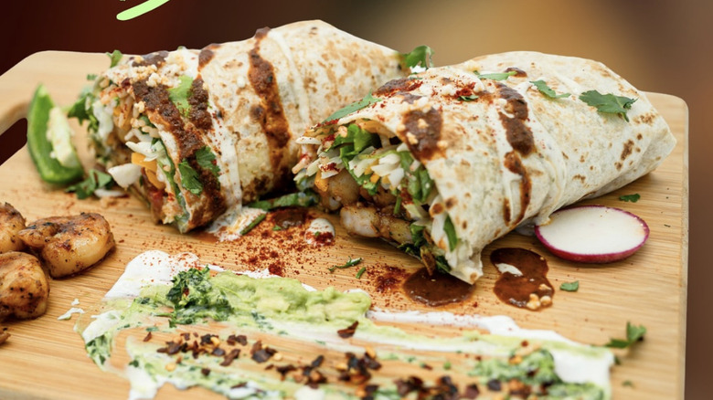 Cilantro Mexican Grill shrimp burrito displayed on wooden board