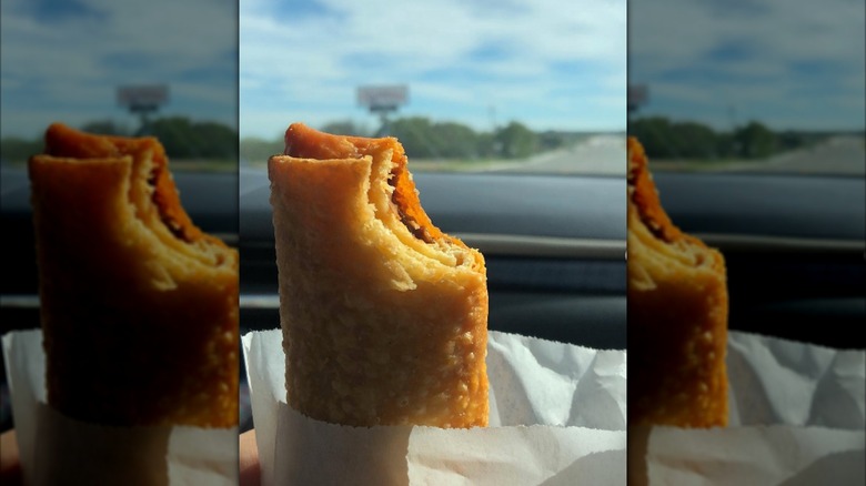 Fried burrito held up on a road trip