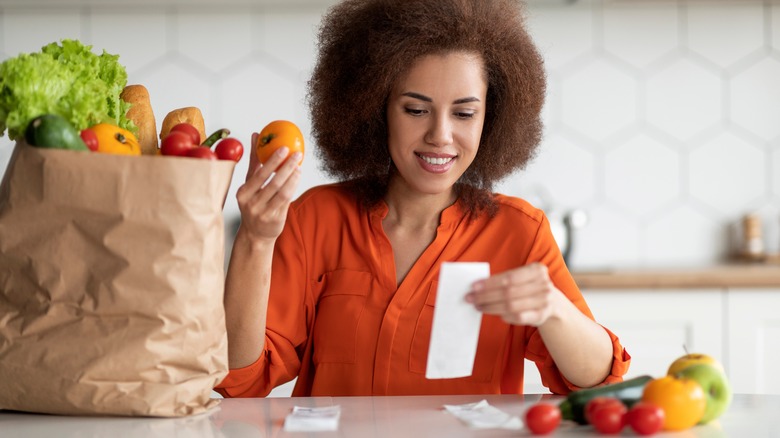 woman smiling at receipts