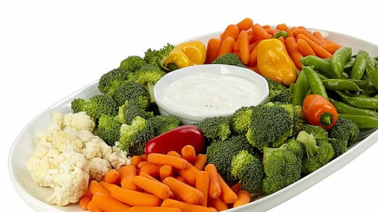 White plate with assorted veggies and ranch dip