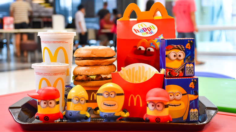 McDonald's Happy Meal box with burgers, fries, drinks, and Minions toys