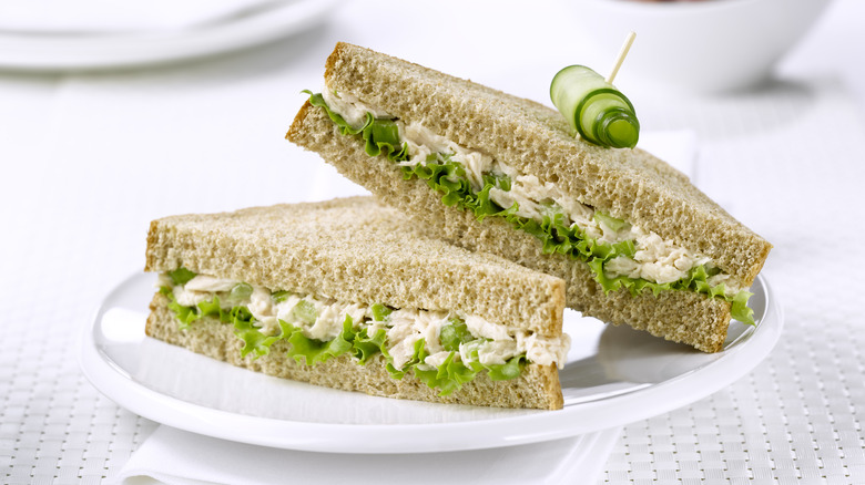 tuna fish sandwich halves garnished with cucumber