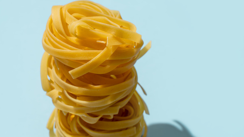 a stack of linguine on a blue background