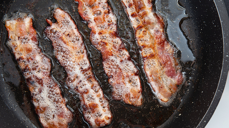 Bacon pan-frying in its own grease