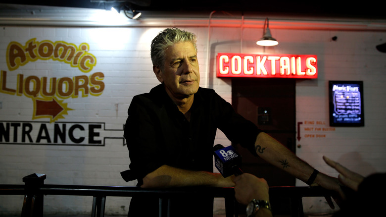 Anthony Bourdain being interviewed by CBS News outside a local bar.